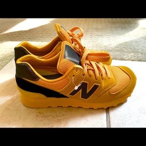 Vibrant golden and black New Balance 547